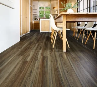 Dark walnut wood-look vinyl flooring installed in a bright modern dining area.