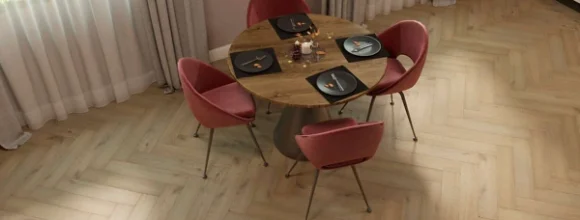 Light oak-look SPC flooring laid in a herringbone pattern in a dining room