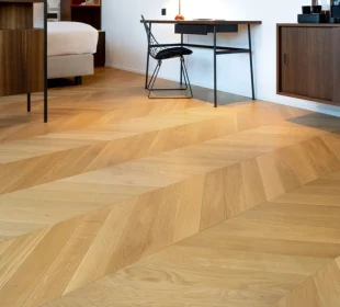 Light wood Chevron parquet flooring in a modern room setup