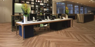 Medium brown wood flooring in a herringbone pattern in a modern office space.