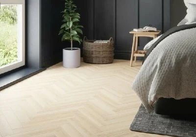 bedroom interior featuring pale blonde chevron engineered parquet flooring